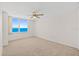 Spacious bedroom featuring neutral carpet, ceiling fan and large window with ocean views at 2987 S Atlantic # 1403, Daytona Beach Shores, FL 32118