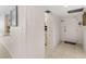 Bright hallway with tile flooring, leading to the kitchen and front door, offers a welcoming entrance at 2987 S Atlantic # 1403, Daytona Beach Shores, FL 32118