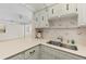 Kitchen countertops, sink, cabinets and backsplash feature seashells at 2987 S Atlantic # 1403, Daytona Beach Shores, FL 32118
