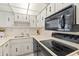 A kitchen with white appliances, bright lighting and lots of storage space at 2987 S Atlantic # 1403, Daytona Beach Shores, FL 32118