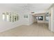 Spacious living room features tile floors, ceiling fan, and access to other rooms at 2987 S Atlantic # 1403, Daytona Beach Shores, FL 32118