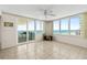 Bright living room featuring tile flooring, ceiling fan, ocean views, and access to a private balcony at 2987 S Atlantic # 1403, Daytona Beach Shores, FL 32118