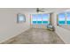 Inviting living room area featuring large window with ocean views, ceiling fan and tile floors at 2987 S Atlantic # 1403, Daytona Beach Shores, FL 32118