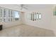 Bright living room features tile floors, a ceiling fan and large windows with views at 2987 S Atlantic # 1403, Daytona Beach Shores, FL 32118