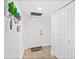 View of the entryway featuring a white door, storage closet and decorative wall art at 2987 S Atlantic # 606, Daytona Beach Shores, FL 32118