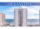 Exterior view of the condo high-rise featuring views of the beach and ocean on a sunny day at 2987 S Atlantic # 606, Daytona Beach Shores, FL 32118