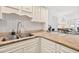 Well-maintained kitchen features granite countertops, stainless steel sink and white cabinets at 2987 S Atlantic # 606, Daytona Beach Shores, FL 32118