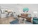 Inviting living room and kitchen with comfortable seating, modern decor and stainless steel appliances at 2987 S Atlantic # 606, Daytona Beach Shores, FL 32118