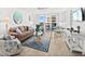 Bright living room featuring comfortable seating, stylish decor, and access to a balcony at 2987 S Atlantic # 606, Daytona Beach Shores, FL 32118