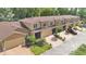 Aerial view of townhomes with garages, brick driveways, and well-maintained landscaping at 302 Tammie Sue Ln, Deland, FL 32724