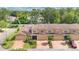 Aerial view of townhomes featuring garages, brick driveways, and meticulous landscaping at 302 Tammie Sue Ln, Deland, FL 32724