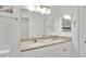 Bathroom with a double sink vanity, granite countertops, bright lighting and a neutral color palette at 302 Tammie Sue Ln, Deland, FL 32724