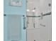 Bathroom features a glass-enclosed shower with custom tile and grab bars at 302 Tammie Sue Ln, Deland, FL 32724