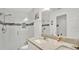 Bright bathroom featuring a glass shower, granite countertop and a tiled floor at 302 Tammie Sue Ln, Deland, FL 32724