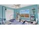 Bright bedroom with a fan, a window with a view, and a workout space at 302 Tammie Sue Ln, Deland, FL 32724