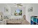 Airy bedroom with a cozy bed, bright decor, and a window overlooking the backyard at 302 Tammie Sue Ln, Deland, FL 32724