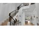Bright foyer boasts high ceilings, modern chandelier, staircase with decorative railing, and views into other living spaces at 302 Tammie Sue Ln, Deland, FL 32724