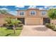 Two-story townhome featuring an attached garage, screened porch, brick driveway, and well-maintained landscaping at 302 Tammie Sue Ln, Deland, FL 32724