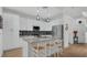 Modern kitchen featuring white cabinets, stainless steel appliances, a mosaic backsplash, and a large island at 302 Tammie Sue Ln, Deland, FL 32724