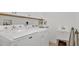 Bright laundry room equipped with white washer, dryer, and utility sink at 302 Tammie Sue Ln, Deland, FL 32724