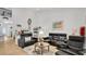 Spacious living room featuring light-colored hardwood floors, neutral walls, and contemporary furnishings at 302 Tammie Sue Ln, Deland, FL 32724