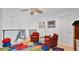 Cozy loft area with red seating, colorful decor, and staircase views at 302 Tammie Sue Ln, Deland, FL 32724