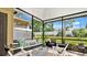 Relaxing screened porch with comfortable seating and view of the lush backyard at 302 Tammie Sue Ln, Deland, FL 32724