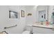 Clean powder room featuring a toilet, marble countertop sink, and grab bar at 302 Tammie Sue Ln, Deland, FL 32724