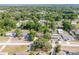Wide aerial view of a neighborhood featuring a mix of homes and lush green trees at 31 Lake Dr, Debary, FL 32713