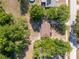 Aerial shot of a well-maintained home with a brown roof, surrounded by lush greenery and a neighborhood at 31 Lake Dr, Debary, FL 32713