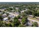 Expansive aerial view of a neighborhood with tree-lined streets and charming single-Gathering homes at 31 Lake Dr, Debary, FL 32713