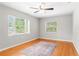 Bright bedroom with hardwood floors, a ceiling fan, and two large windows at 31 Lake Dr, Debary, FL 32713