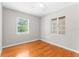 Bedroom featuring hardwood floors, two windows, and a ceiling fan at 31 Lake Dr, Debary, FL 32713