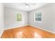 Bright bedroom with hardwood floors, two windows, and a ceiling fan at 31 Lake Dr, Debary, FL 32713