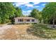 Cozy one-story house with a well-maintained lawn, enhanced by mature shade trees at 31 Lake Dr, Debary, FL 32713