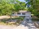 A single-story house with a driveway and lawn, partially obscured by trees at 31 Lake Dr, Debary, FL 32713