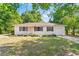 Charming single-story home with white exterior, brown shutters, and a well-manicured front lawn at 31 Lake Dr, Debary, FL 32713