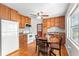 Eat-in kitchen features wooden cabinets, ceiling fan, and appliances, with hardwood floors at 31 Lake Dr, Debary, FL 32713