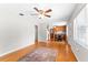 Spacious living room with hardwood floors, ceiling fan, and access to the eat-in kitchen at 31 Lake Dr, Debary, FL 32713