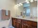 Bathroom featuring a double vanity with granite countertop, and decorative light fixtures at 3148 Bailey Ann Dr, Ormond Beach, FL 32174