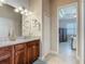 Bathroom vanity with a granite countertop and a view to an adjacent bedroom at 3148 Bailey Ann Dr, Ormond Beach, FL 32174