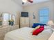 Cozy bedroom featuring a plush bed, dresser with mirror, accent seating, and a ceiling fan at 3148 Bailey Ann Dr, Ormond Beach, FL 32174