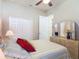 Bedroom with neutral tones, plush bed, dresser, and a ceiling fan providing air circulation at 3148 Bailey Ann Dr, Ormond Beach, FL 32174