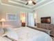 Bedroom with access to a bathroom, neutral walls, platform bed, and dresser with a television at 3148 Bailey Ann Dr, Ormond Beach, FL 32174