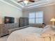 Bedroom with a platform bed, dressers, chair, neutral walls, and plantation shutters at 3148 Bailey Ann Dr, Ormond Beach, FL 32174