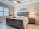 Bedroom with neutral walls, plantation shutters, a platform bed, and matching bedside tables at 3148 Bailey Ann Dr, Ormond Beach, FL 32174