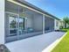 Wide angle view of the screened in lanai and the green grass of the backyard at 3148 Bailey Ann Dr, Ormond Beach, FL 32174