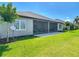 A view of a home and backyard, featuring a screened lanai on a sunny day at 3148 Bailey Ann Dr, Ormond Beach, FL 32174