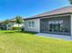 Exterior shot of a home featuring a screened lanai and green backyard at 3148 Bailey Ann Dr, Ormond Beach, FL 32174