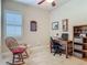 Bright office with a classic rocking chair, desk, and bookcase at 3148 Bailey Ann Dr, Ormond Beach, FL 32174